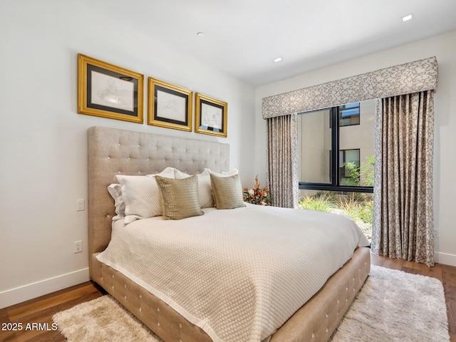 bedroom with baseboards and wood finished floors