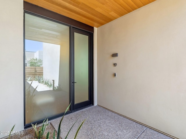 property entrance with stucco siding