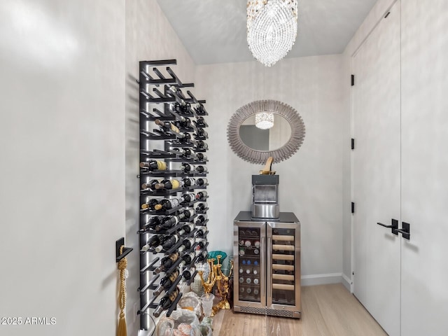wine cellar featuring a chandelier and wood finished floors