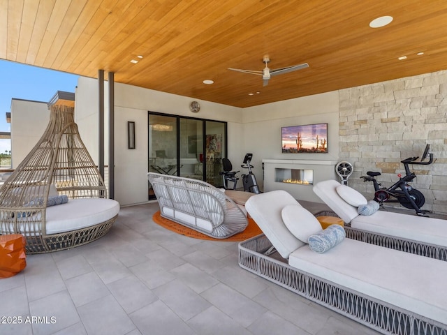 view of patio / terrace with an outdoor living space with a fireplace