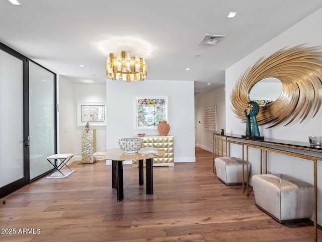 dining space with wood finished floors, a chandelier, baseboards, and recessed lighting