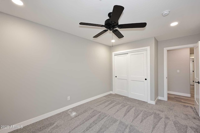 unfurnished bedroom with carpet, ceiling fan, and a closet