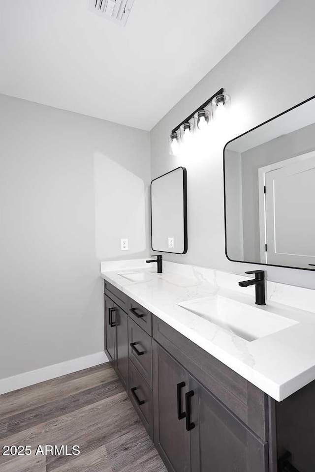 bathroom with hardwood / wood-style flooring and vanity