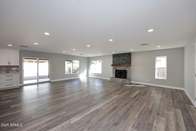 unfurnished living room with hardwood / wood-style flooring and a fireplace