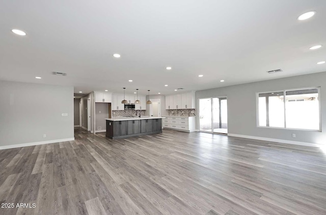 unfurnished living room with hardwood / wood-style flooring