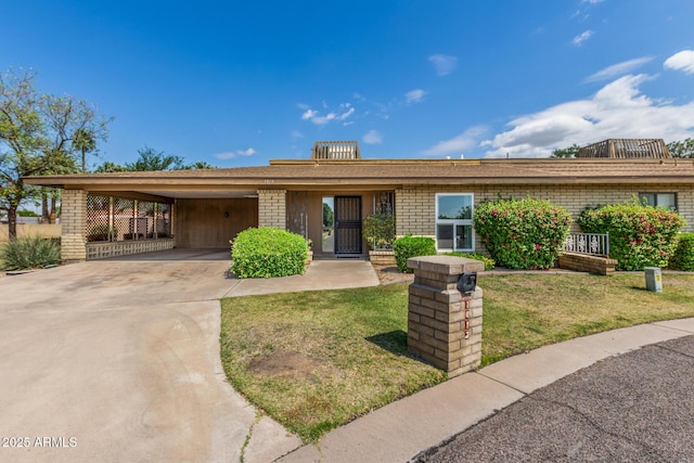 1012 E Wagon Wheel Dr, Phoenix, AZ 85020 - single story home with driveway, a front yard, brick siding, and an attached carport