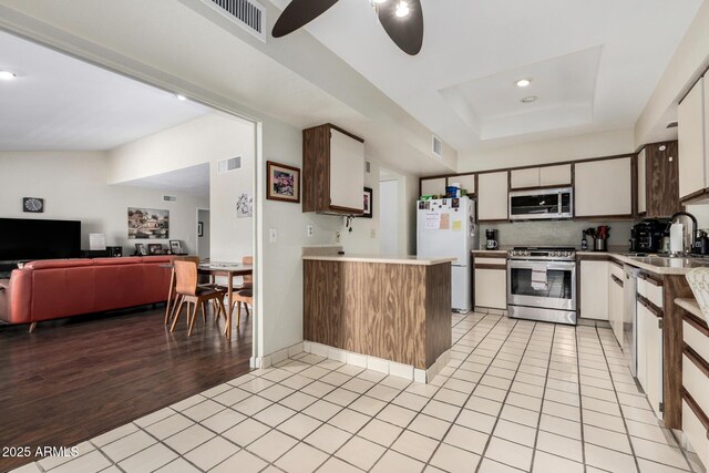 1012 E Wagon Wheel Dr, Phoenix, AZ 85020 - kitchen featuring stainless steel appliances, light countertops, a sink, visible vents, and open floor plan