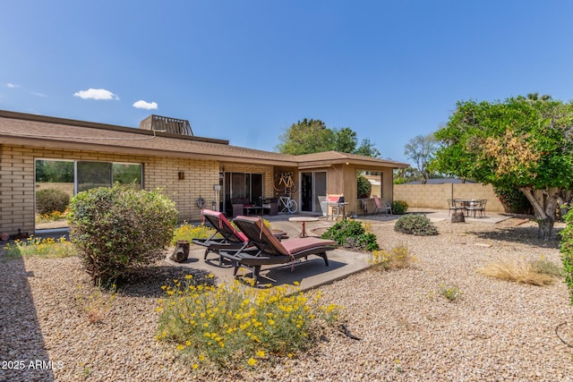 1012 E Wagon Wheel Dr, Phoenix, AZ 85020 - back of house featuring a patio, brick siding, and fence