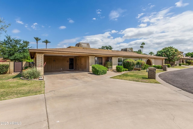 1012 E Wagon Wheel Dr, Phoenix, AZ 85020 - ranch-style house with a front lawn, driveway, a garage, and brick siding