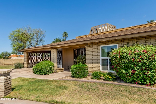 1012 E Wagon Wheel Dr, Phoenix, AZ 85020 - view of front of home with fence, a front lawn, and brick siding