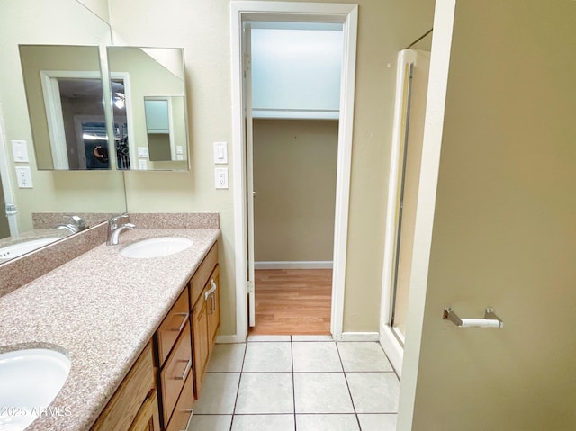 924 S Hacienda Dr Unit C, Tempe, AZ 85281 - bathroom featuring a stall shower, tile patterned flooring, double vanity, and baseboards