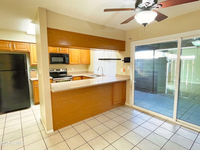 924 S Hacienda Dr Unit C, Tempe, AZ 85281 - kitchen featuring black appliances, a sink, light countertops, a peninsula, and light tile patterned floors