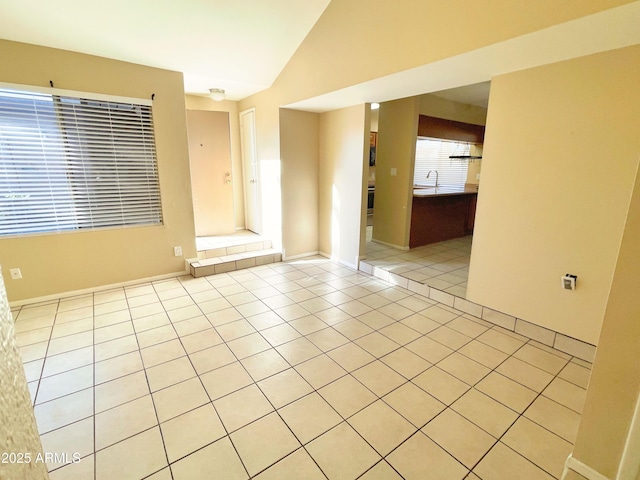 924 S Hacienda Dr Unit C, Tempe, AZ 85281 - spare room with vaulted ceiling, light tile patterned floors, a sink, and baseboards