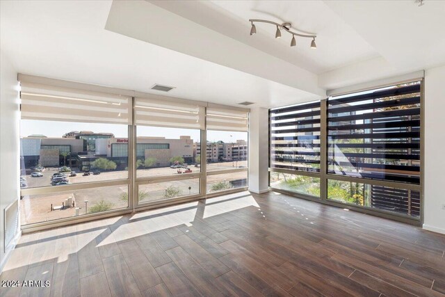 unfurnished sunroom featuring track lighting