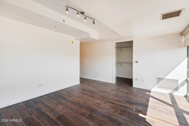 unfurnished room with dark wood-type flooring