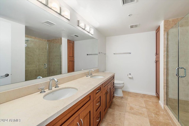 bathroom with vanity, toilet, and a shower with shower door