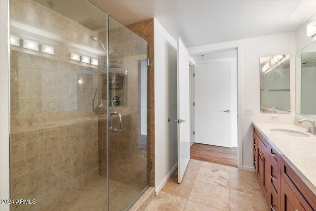 bathroom with vanity, hardwood / wood-style floors, and an enclosed shower