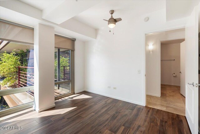 spare room with ceiling fan and dark wood-type flooring