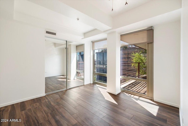 spare room featuring dark wood-type flooring