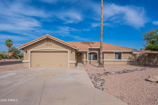 17207 E El Pueblo Blvd, Fountain Hills, AZ 85268 - mediterranean / spanish-style home featuring stucco siding, concrete driveway, an attached garage, and a tiled roof
