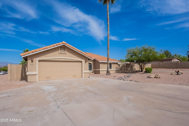 17207 E El Pueblo Blvd, Fountain Hills, AZ 85268 - view of front of house featuring stucco siding, driveway, a garage, and a tiled roof