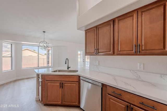 17207 E El Pueblo Blvd, Fountain Hills, AZ 85268 - kitchen with stainless steel dishwasher, a sink, brown cabinetry, a chandelier, and a peninsula