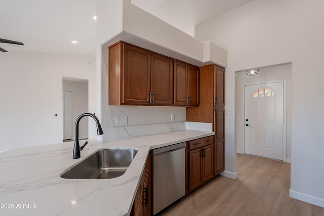 17207 E El Pueblo Blvd, Fountain Hills, AZ 85268 - kitchen with dishwasher, a sink, light stone counters, and light wood-style floors