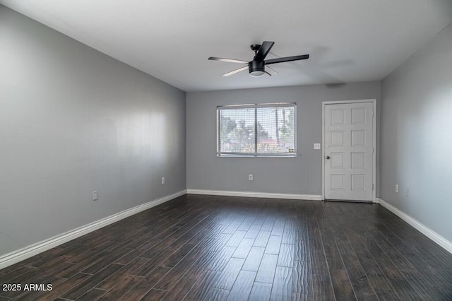 unfurnished room featuring dark wood-type flooring and ceiling fan