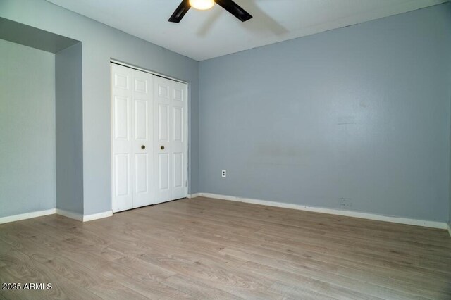 unfurnished bedroom with a closet, ceiling fan, and light hardwood / wood-style flooring