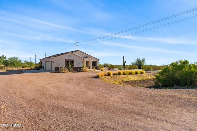 1623 E Hidalgo St, Apache Junction, AZ 85119 - single story home featuring dirt driveway, a garage, and stucco siding