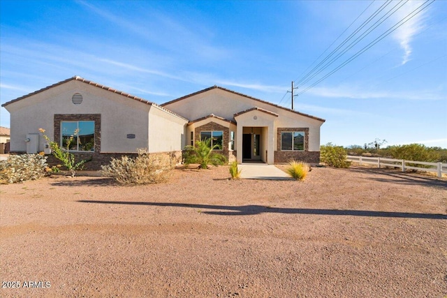 1623 E Hidalgo St, Apache Junction, AZ 85119 - mediterranean / spanish home featuring stucco siding, stone siding, and a tile roof