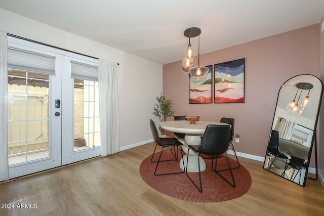 dining room with french doors and light hardwood / wood-style floors