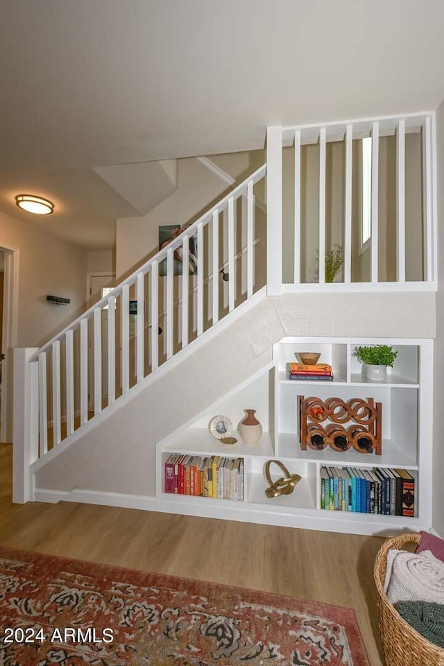 stairs with hardwood / wood-style floors