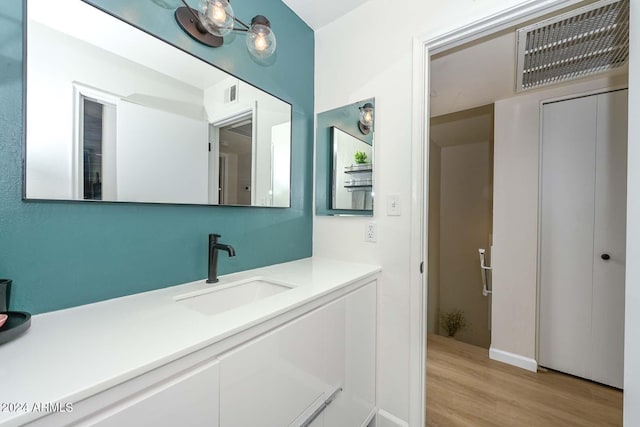 bathroom featuring hardwood / wood-style floors and vanity