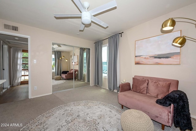 living room featuring ceiling fan and light carpet