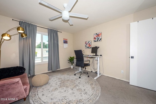 carpeted office space with ceiling fan