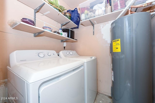 clothes washing area with water heater and washer and clothes dryer