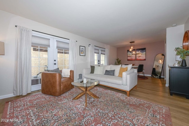 living room featuring french doors and light wood-type flooring