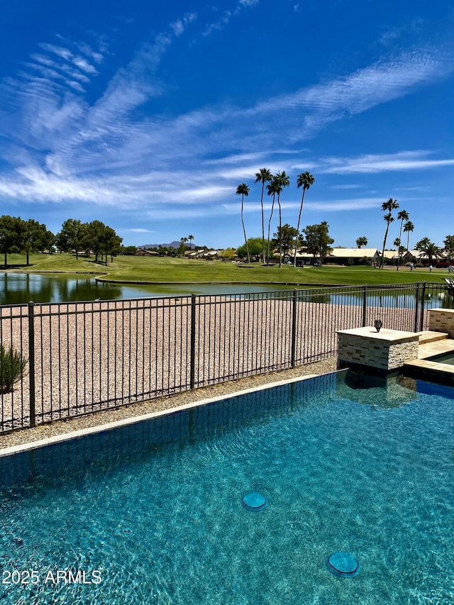 view of swimming pool featuring a water view and a fenced backyard