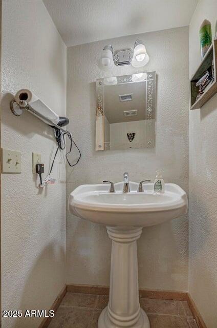 bathroom with tile patterned flooring and sink