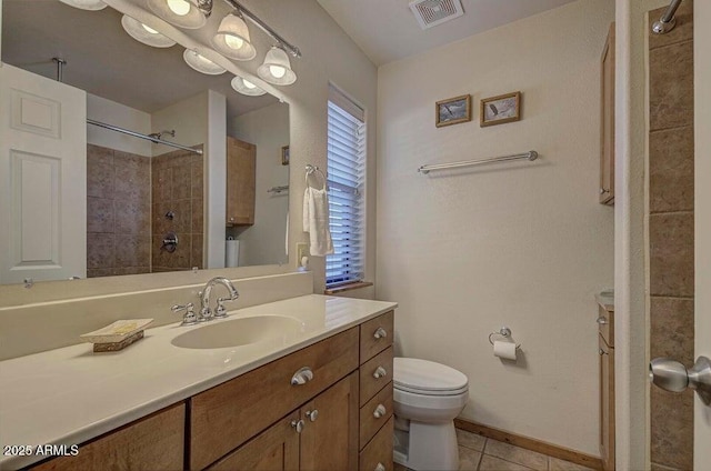 bathroom featuring vanity, tile patterned floors, and toilet