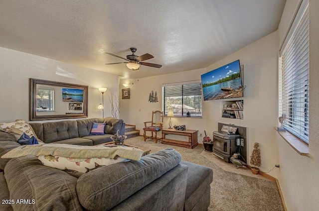 living room with ceiling fan, light carpet, and a textured ceiling