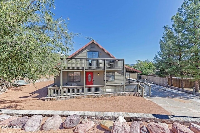 view of front of property featuring a balcony and covered porch