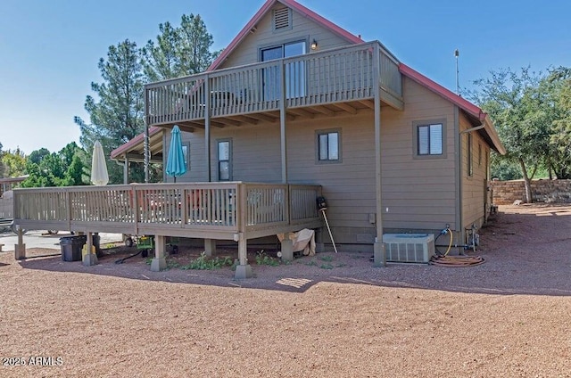 rear view of property featuring a deck and central air condition unit