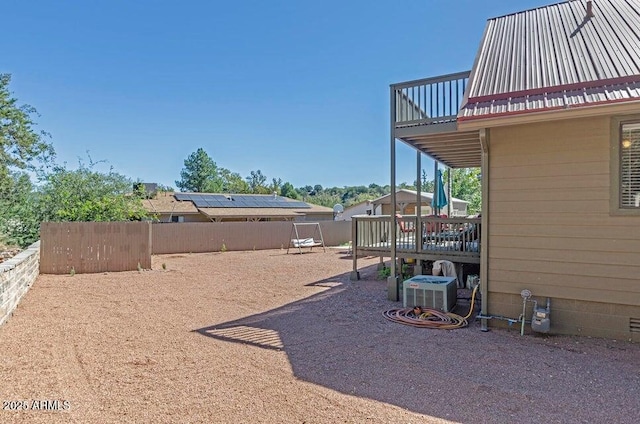 view of yard with ac unit and a balcony