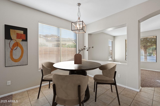 tiled dining area with a notable chandelier