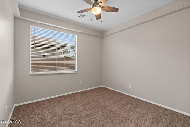 carpeted spare room featuring ceiling fan