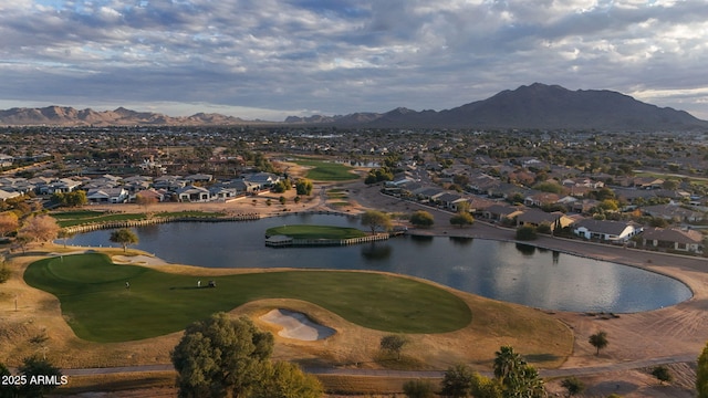 birds eye view of property with a water and mountain view