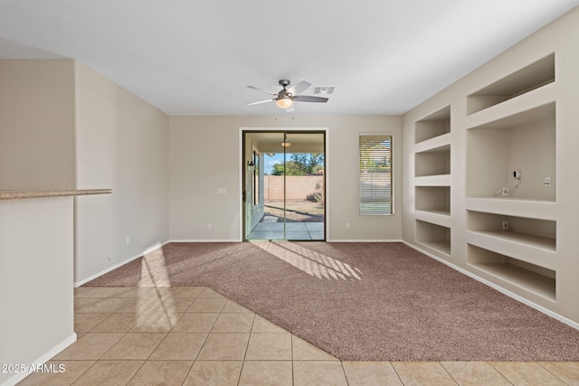 unfurnished living room featuring built in features, ceiling fan, and light tile patterned flooring