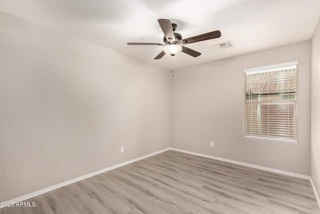 empty room featuring ceiling fan and light wood-type flooring